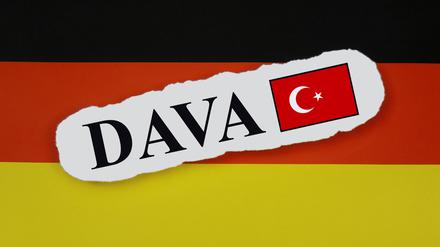 Auf einer Deutschlandfahne liegt der Schriftzug DAVA mit einer türkischen Flagge. 