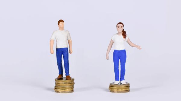 Konzept des geschlechtsspezifischen Lohngefälles mit einem Mann und einer Frau, die auf einer unterschiedlichen Anzahl von Münzen stehen