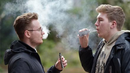 Zwei junge Menschen rauchen eine E-Zigarette. Seit Jahren sinkt die Zahl der Raucher in Großbritannien. 2022 waren es noch 12,9 Prozent der Erwachsenen. Doch Experten warnen, das Ziel eines „rauchfreien“ 2030 werde Stand jetzt deutlich verfehlt. 