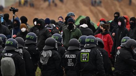 Polizisten stehen Aktivisten in Lützerath gegenüber.
