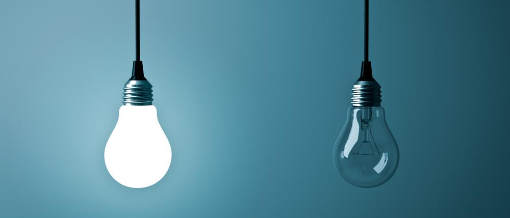 Two hanging light bulbs , One glowing and one turned off on dark green blue background . 3D rendering.