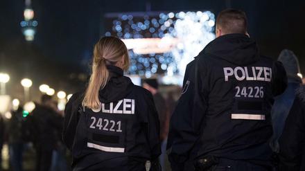 Polizisten beobachten Deutschlands größte Silvesterparty am Brandenburger Tor.