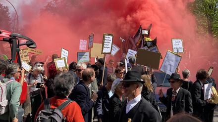 Berlin: Teilnehmer der linken Demonstration «MyGruni» stehen mit Plakaten im Villenviertel Berlin-Grunewald, eine Rauchfackel wurde gezündet.