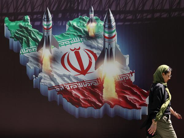 An Iranian woman walks past an anti-Israel banner with a picture of Iranian missiles on a street in Tehran, Iran April 19, 2024. Majid Asgaripour/WANA (West Asia News Agency) via REUTERS ATTENTION EDITORS - THIS IMAGE HAS BEEN SUPPLIED BY A THIRD PARTY.   ATTENTION EDITORS - THIS PICTURE WAS PROVIDED BY A THIRD PARTY. 