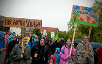 Menschen mit Plakaten und Transparenten protestieren in Haßleben (Brandenburg) bei einer Demonstration gegen Massentierhaltung. Unter dem Motto "Wir haben es satt" demonstrieren die Teilnehmer gegen die geplante Schweinemastanlage einer niederländischen Firma mit 37.000 Plätzen.