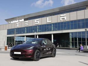 (FILES) A Tesla Model Y car stands in front of the company’s plant as Tesla CEO Elon Musk visits the company’s electric car plant in Gruenheide near Berlin, eastern Germany, on March 13, 2024, as employees resumed work after production had to be halted due to a suspected arson attack that caused a power outage. 