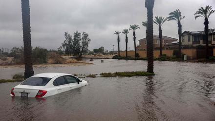 CATHEDRAL CITY, CALIFORNIA - AUGUST 20: A car is partially submerged in floodwaters as Tropical Storm Hilary moves through the area on August 20, 2023 in Cathedral City, California. Southern California is under a first-ever tropical storm warning as Hilary impacts parts of California, Arizona and Nevada. All California state beaches have been closed in San Diego and Orange counties in preparation for the impacts from the storm, which was downgraded from hurricane status.   Mario Tama/Getty Images/AFP (Photo by MARIO TAMA / GETTY IMAGES NORTH AMERICA / Getty Images via AFP)