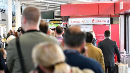 Passagiere warten an einem Serviceschalter von Air Berlin auf dem Flughafen Tegel in Berlin. Wegen Krankmeldungen zahlreicher Piloten hat Air Berlin am Dienstag Dutzende Flüge abgesagt.