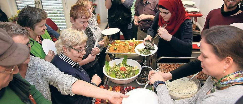 Vorbehalte abbauen. Bei Couscous, gefüllten Weinblättern und Hummus kamen Flüchtlinge und bedürftige Besucher der Suppenküche ins Gespräch.