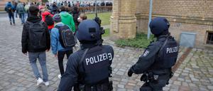 Police officers of a special unit lead pupils away from a vocational school in Potsdam, northeastern Germany, during a major police operation on February 27, 2023, following an amok alert.