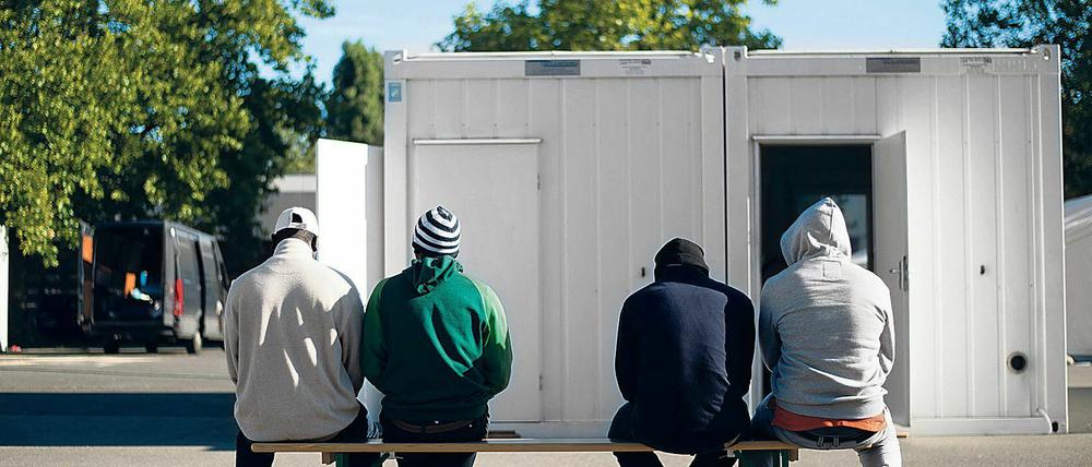 Dieses Foto zeigt Flüchtlinge vor einer Unterkunft in Berlin-Spandau.