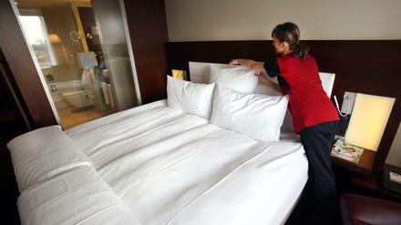 Ein Zimmermädchen macht in Köln in einem Hotel das Bett (Symbolbild).