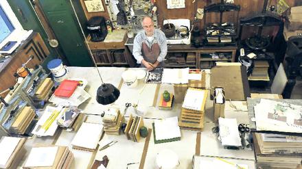 Gut zu tun. Christian Klünder betreibt seine Buchbinderei in Berlin-Moabit seit 30 Jahren. „Man muss sich auf Kundenwünsche einlassen“, sagt er. Foto: Paul Zinken